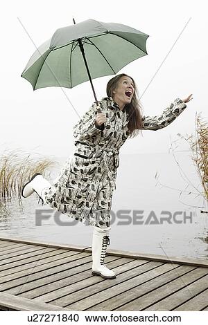 Older woman carrying umbrella on dock View Large Photo Image Stock Image - Older woman carrying umbrella on dock. Fotosearch