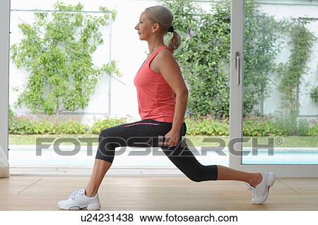 Older woman exercising at home View Large Photo Image Stock Photo - Older woman exercising at home. Fotosearch