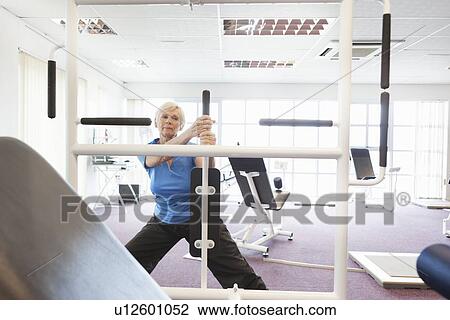 Older woman exercising in gym View Large Photo Image Stock Image - Older woman exercising in gym. Fotosearch