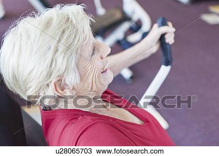 Older woman exercising in gym View Large Photo Image Stock Image - Older woman exercising in gym. Fotosearch