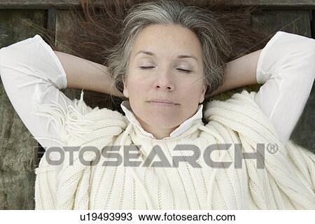 Older woman laying on wooden dock View Large Photo Image Stock Image - Older woman laying on wooden dock. Fotosearch