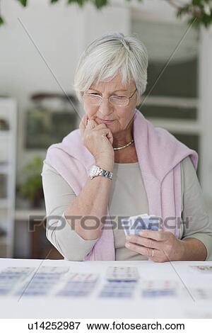 Older woman playing cards View Large Photo Image Stock Photo - Older woman playing cards. Fotosearch