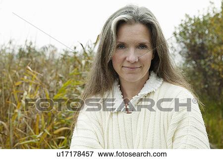Older woman smiling outdoors View Large Photo Image Stock Photo - Older woman smiling outdoors. Fotosearch
