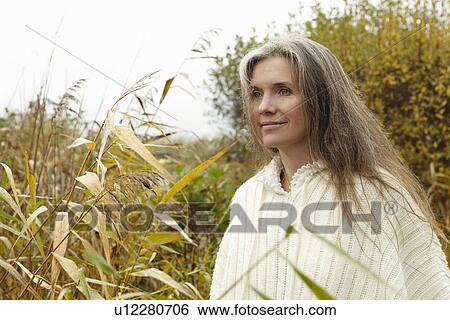 Stock Photograph - Older woman smiling outdoors. Fotosearch