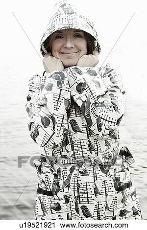 Older woman wearing raincoat outdoors View Large Photo Image Stock Image - Older woman wearing raincoat outdoors. Fotosearch