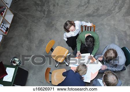 Overhead view of business people at desk View Large Photo Image Stock Image - Overhead view of business people at desk. Fotosearch