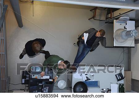 Overhead view of businessmen in office View Large Photo Image Picture - Overhead view of businessmen in office. Fotosearch