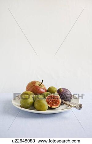 Stock Image - Plate of fruit on table. Fotosearch