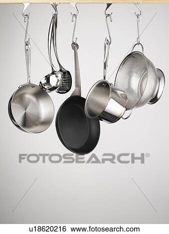 Stock Photograph - Pots and pans hanging from hooks. Fotosearch