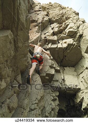 Picture - Rock climber scaling steep rock face. Fotosearch
