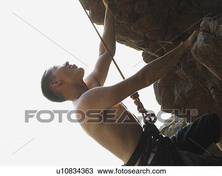 Rock climber scaling steep rock face View Large Photo Image Stock Image - Rock climber scaling steep rock face. Fotosearch