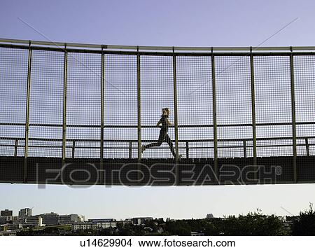 Runner crossing skybridge View Large Photo Image Picture - Runner crossing skybridge. Fotosearch