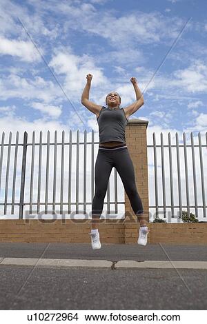 Runner jumping for joy outdoors View Large Photo Image Picture - Runner jumping for joy outdoors. Fotosearch
