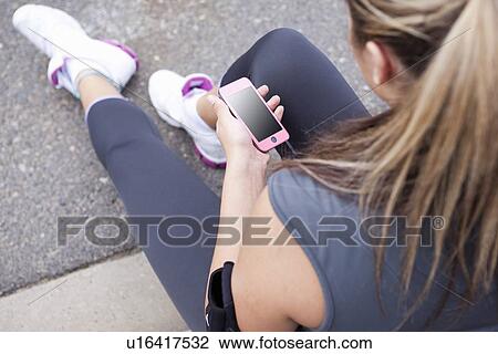 Runner listening to mp3 player outdoors View Large Photo Image Stock Image - Runner listening to mp3 player outdoors. Fotosearch