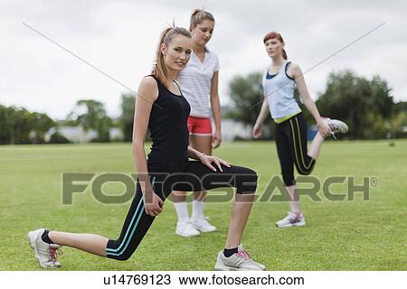 Runners stretching in park View Large Photo Image Stock Image - Runners stretching in park. Fotosearch