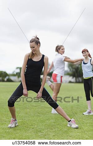Runners stretching in park View Large Photo Image Stock Photo - Runners stretching in park. Fotosearch