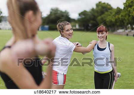 Runners stretching in park View Large Photo Image Stock Photo - Runners stretching in park. Fotosearch
