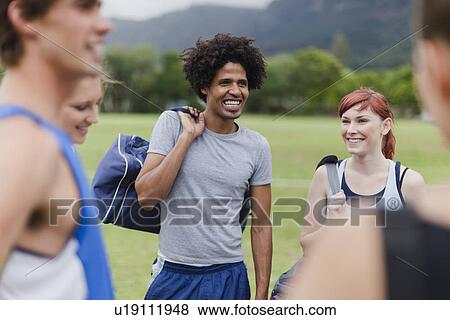 Runners talking in park View Large Photo Image Stock Photo - Runners talking in park. Fotosearch