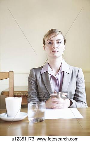Serious businesswoman sitting in cafe View Large Photo Image Stock Image - Serious businesswoman sitting in cafe. Fotosearch