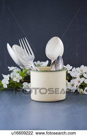 Stock Image - Silverware in ceramic mug. Fotosearch