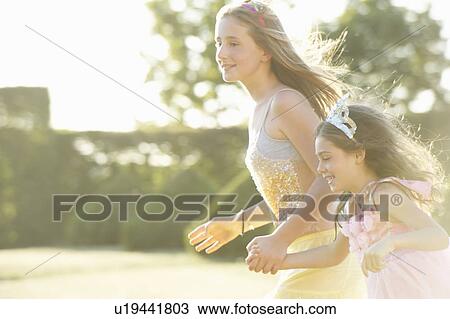 Sisters playing together outdoors View Large Photo Image Stock Image - Sisters playing together outdoors. Fotosearch