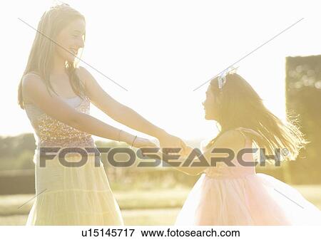 Sisters playing together outdoors View Large Photo Image Stock Photo - Sisters playing together outdoors. Fotosearch
