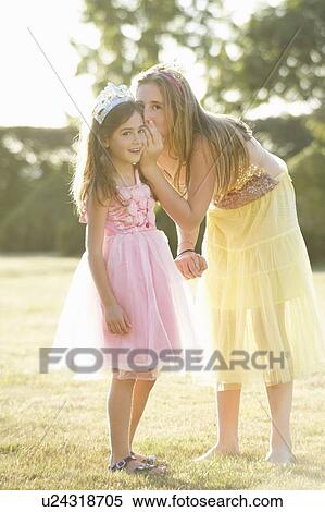Sisters whispering outdoors View Large Photo Image Stock Photography - Sisters whispering outdoors. Fotosearch