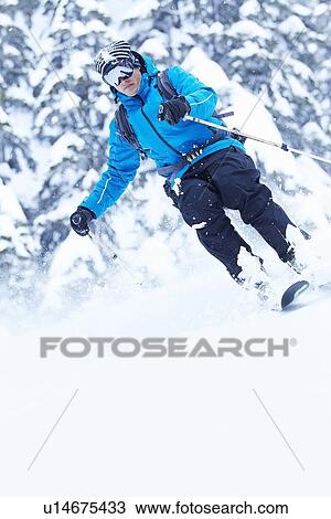 Skier coasting down snowy slope View Large Photo Image Stock Image - Skier coasting down snowy slope. Fotosearch