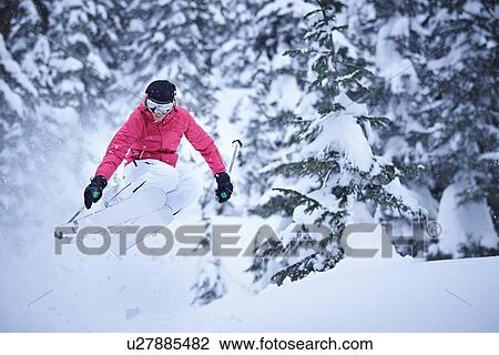 Skier jumping on snowy slope View Large Photo Image Stock Image - Skier jumping on snowy slope. Fotosearch