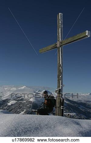 Skier leaning against wooden cross View Large Photo Image Stock Image - Skier leaning against wooden cross. Fotosearch