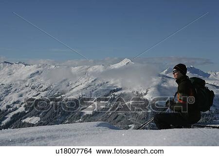 Picture - Skier overlooking snowy mountains. Fotosearch