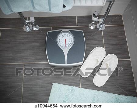 Slippers and weighing scale in bathroom View Large Photo Image Picture - Slippers and weighing scale in bathroom. Fotosearch