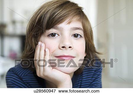 Smiling boy resting chin in hand View Large Photo Image Stock Photo - Smiling boy resting chin in hand. Fotosearch
