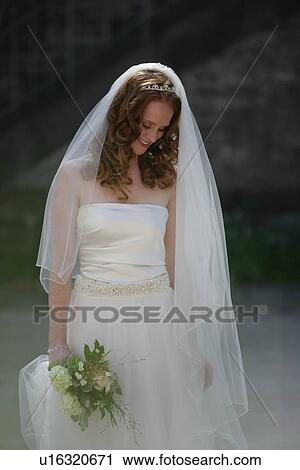Smiling bride holding bouquet View Large Photo Image Stock Image - Smiling bride holding bouquet. Fotosearch