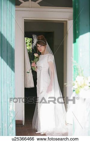 Smiling bride standing in doorway View Large Photo Image Stock Photograph - Smiling bride standing in doorway. Fotosearch