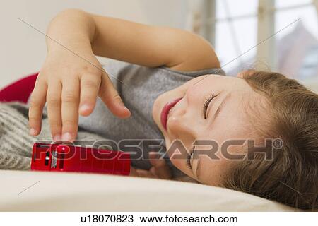 Smiling girl playing with toy bus in bed View Large Photo Image Stock Image - Smiling girl playing with toy bus in bed. Fotosearch
