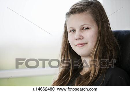 Smiling girl sitting indoors View Large Photo Image Stock Image - Smiling girl sitting indoors. Fotosearch
