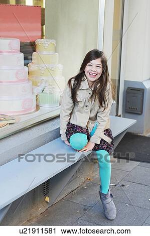 Smiling girl sitting outside bakery View Large Photo Image Stock Image - Smiling girl sitting outside bakery. Fotosearch