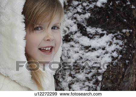 Smiling girl standing outdoors in snow View Large Photo Image Stock Photo - Smiling girl standing outdoors in snow. Fotosearch