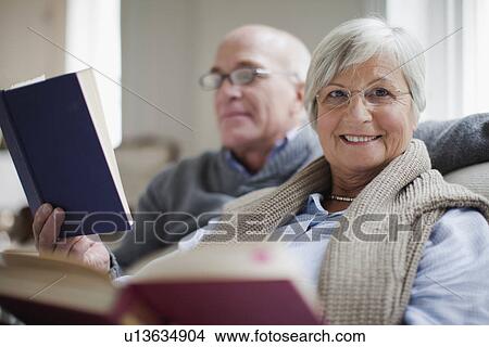 Smiling older couple reading books View Large Photo Image Picture - Smiling older couple reading books. Fotosearch