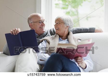 Smiling older couple reading books View Large Photo Image Stock Photo - Smiling older couple reading books. Fotosearch