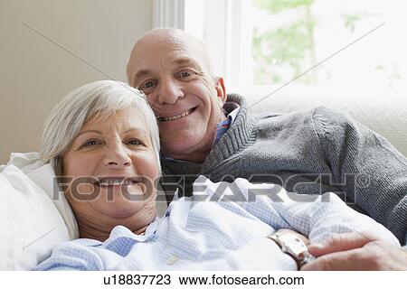 Stock Image - Smiling older couple relaxing together. Fotosearch