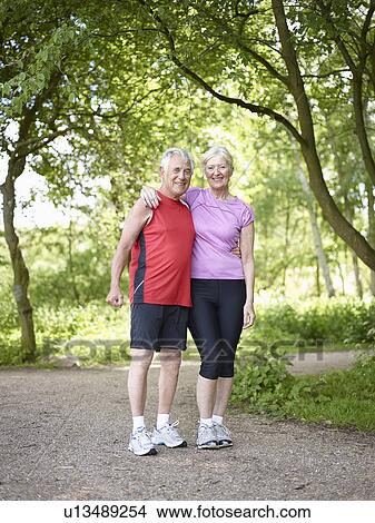 Picture - Smiling older couple standing outside. Fotosearch