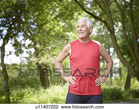 Smiling older man standing outside View Large Photo Image Stock Image - Smiling older man standing outside. Fotosearch