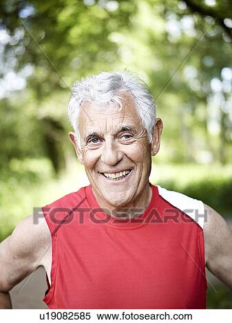 Stock Photography - Smiling older man standing outside. Fotosearch
