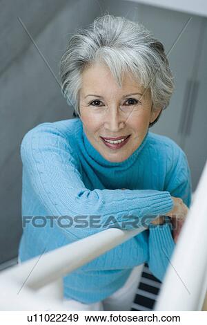 Smiling older woman climbing stairs View Large Photo Image Stock Photo - Smiling older woman climbing stairs. Fotosearch