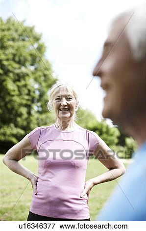Smiling older woman standing outside View Large Photo Image Stock Photo - Smiling older woman standing outside. Fotosearch