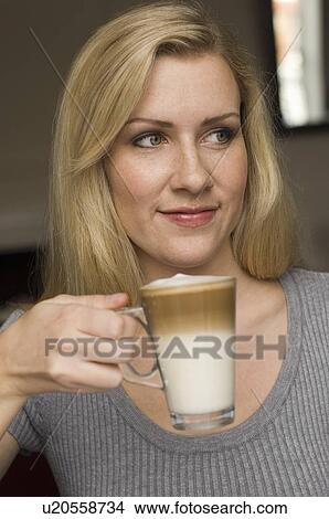 Smiling woman having cup of coffee View Large Photo Image Picture - Smiling woman having cup of coffee. Fotosearch