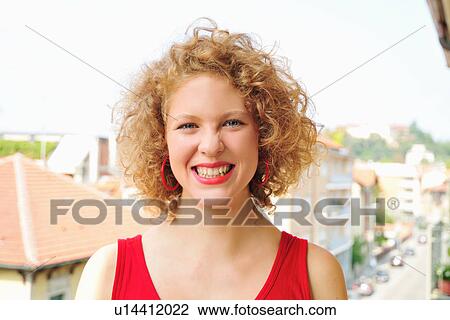 Smiling woman standing on balcony View Large Photo Image Stock Image - Smiling woman standing on balcony. Fotosearch