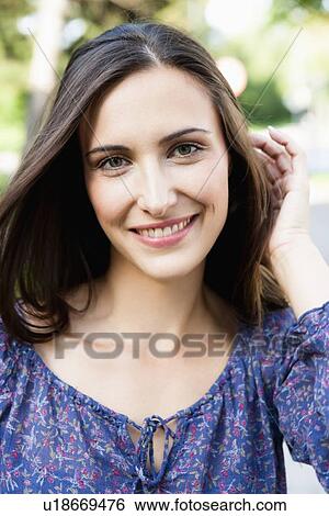 Stock Photograph - Smiling woman standing outdoors. Fotosearch